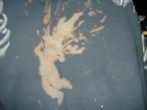 Close detail of bleach-painted splatter and organic silhouettes on fabric