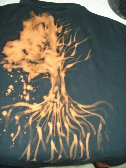 Bleach-painted tree with roots spreading across a dark shirt
