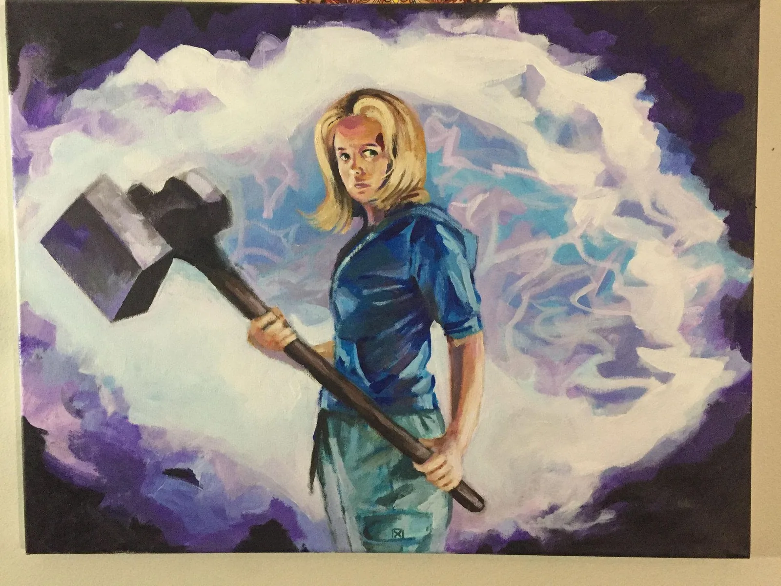 Buffy holding a large hammer against a smoky purple-blue background