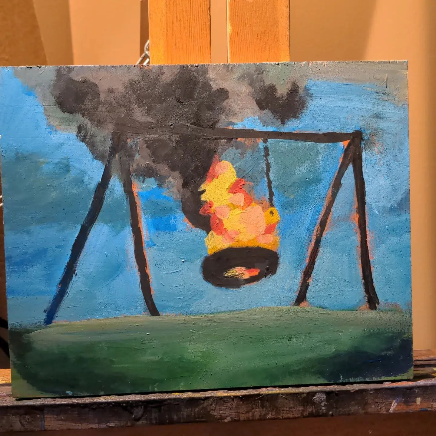 Painting of a tire swing engulfed in fire