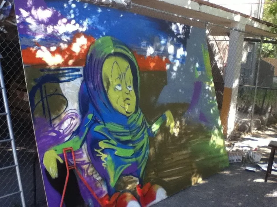 FUSE mural work in progress on the wood panel outdoors