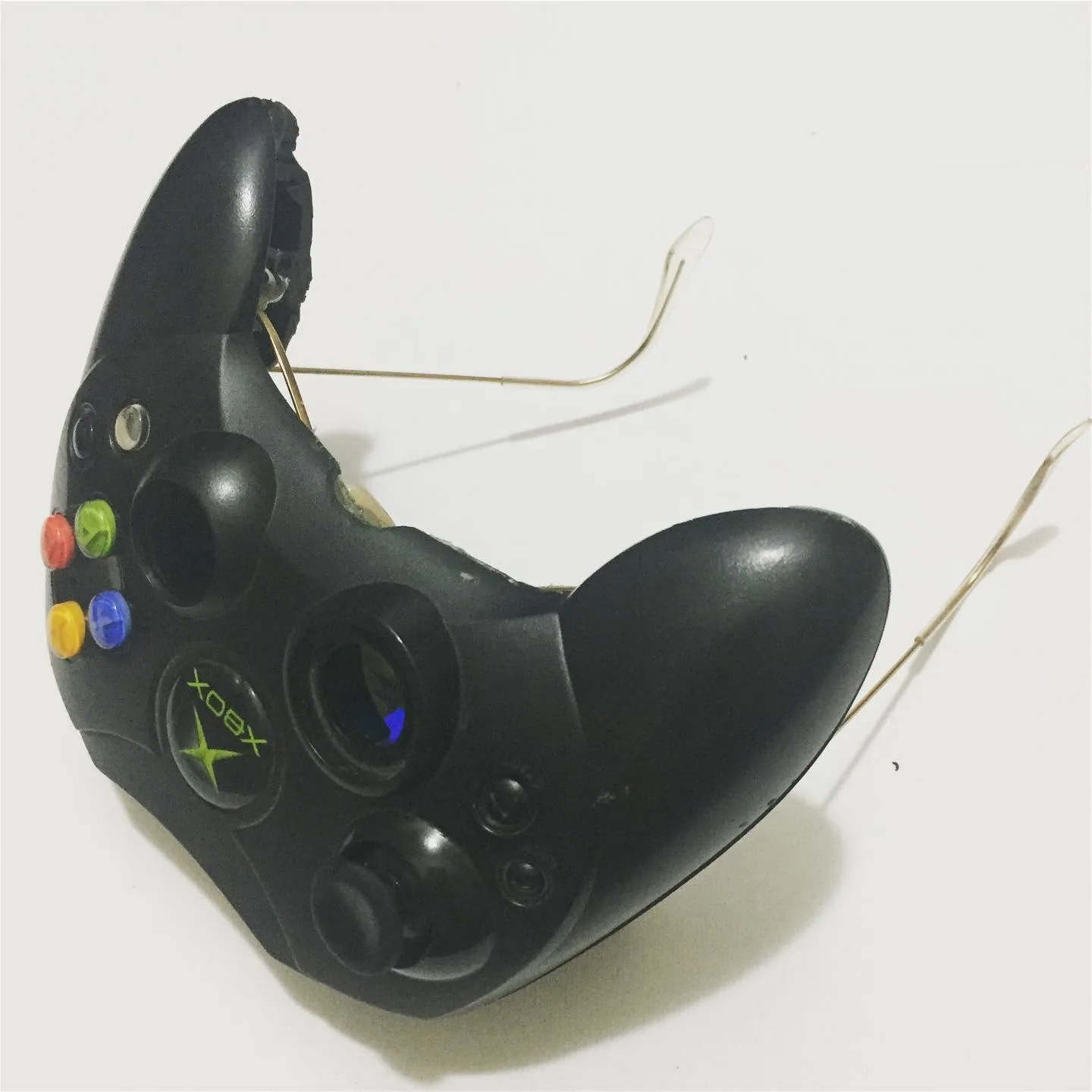 Angled white-background photograph of Xbox controller sunglasses