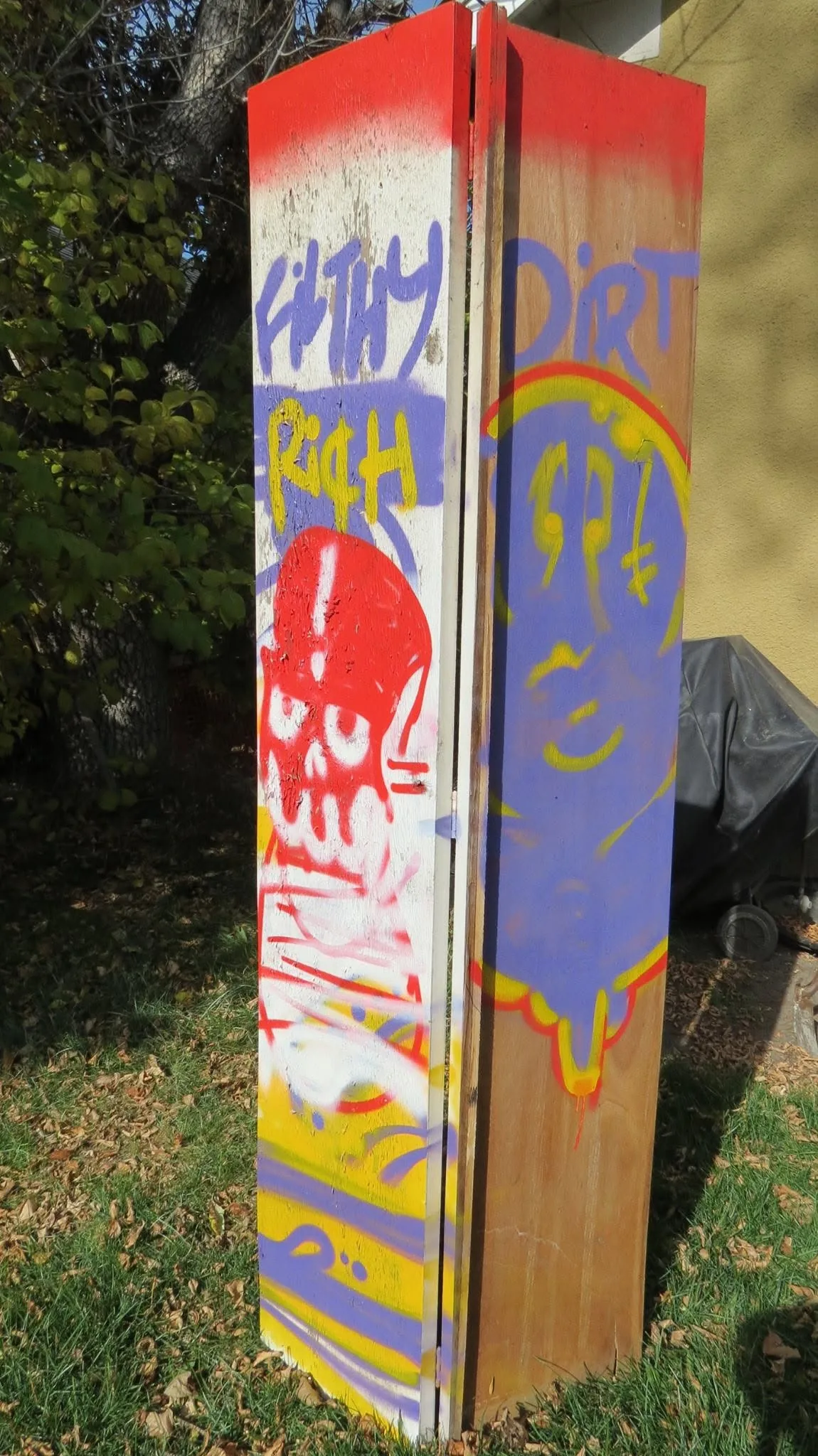 Untitled spray-paint study on closet doors with Filthy Rich, a red skull and Dirt in purple, yellow and red, 2014